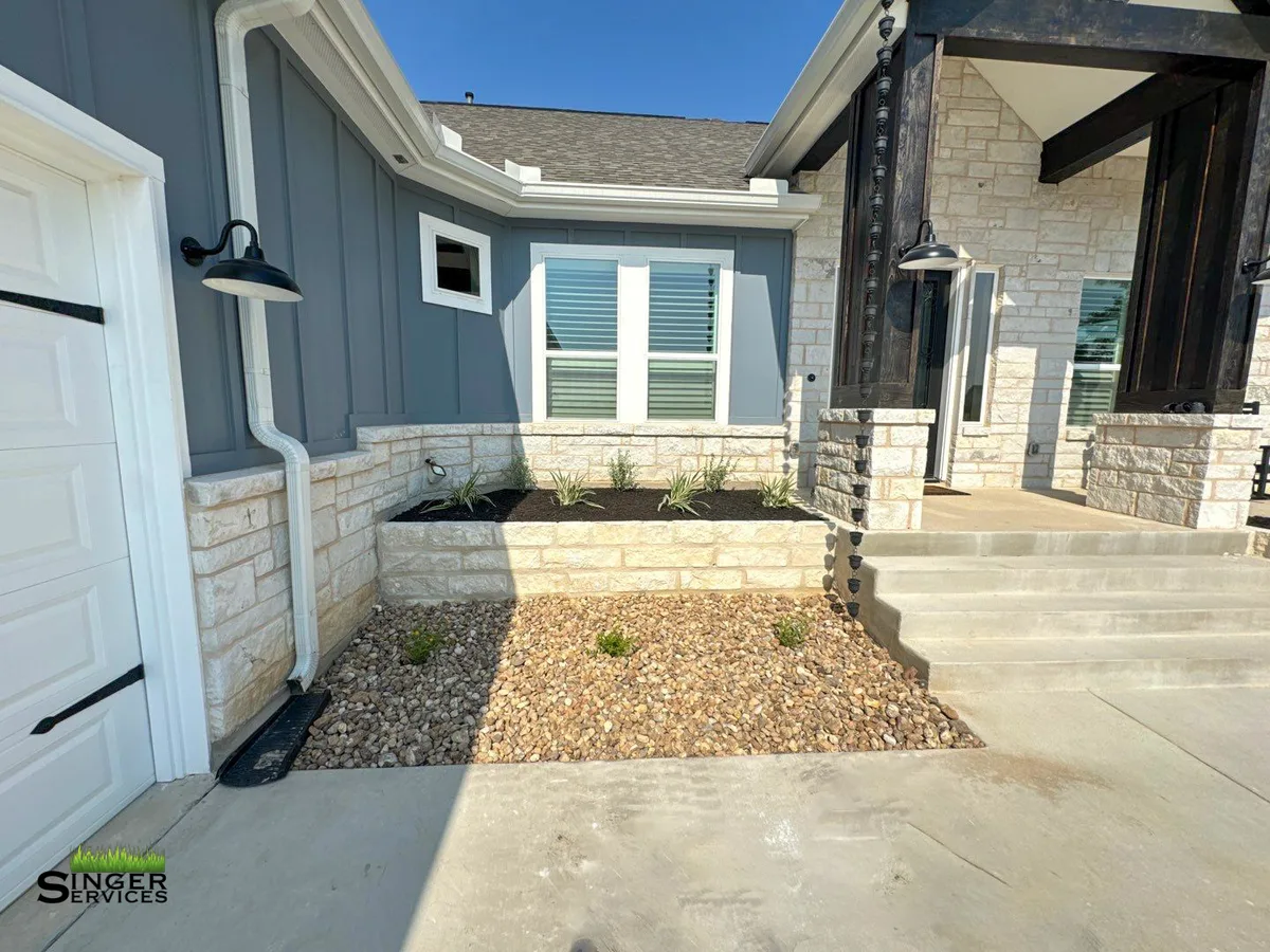 Native planting and stonework on a rural Blanco property
