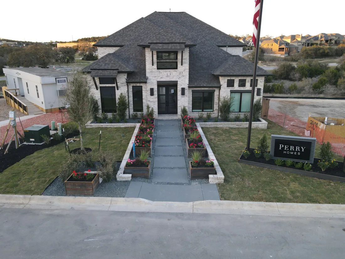 Perry Homes model home in Johnson Ranch with a paver entry walkway and corten steel planters