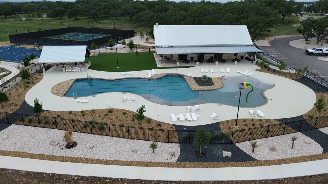 Aerial view of the Belle Oaks amenity center with the pool deck, pavilion, and planted beds
