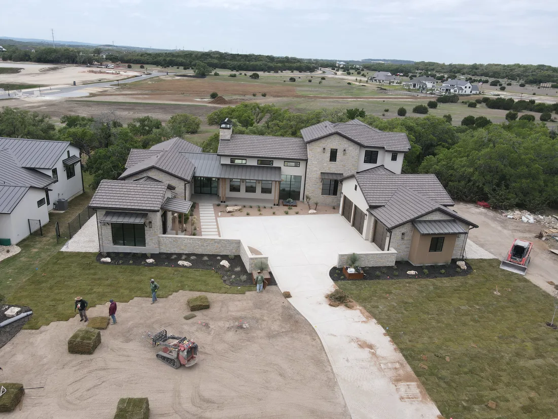 Sod going down over a bare lot at a Brad Moore custom home during installation