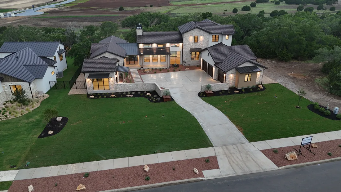 Wider dusk view of the finished landscape at the Brad Moore custom home