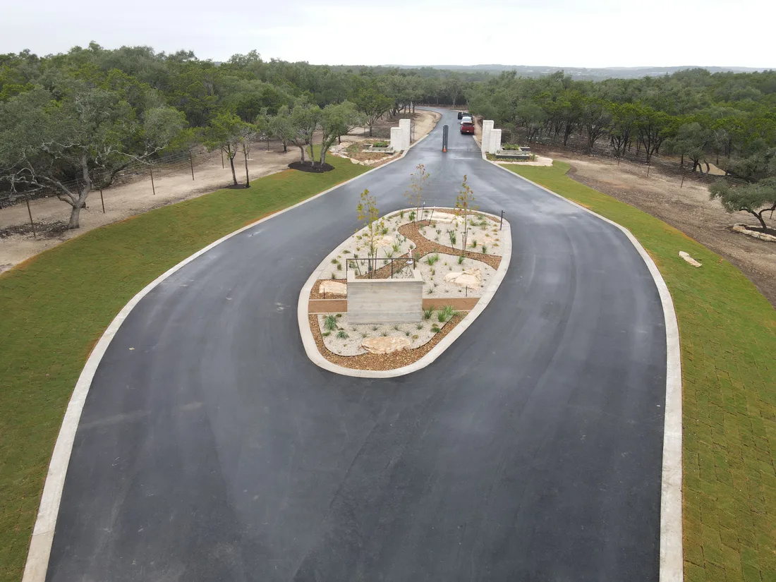 Aerial view of the Ranches at Canyon Crossing entry drive curving around a planted island