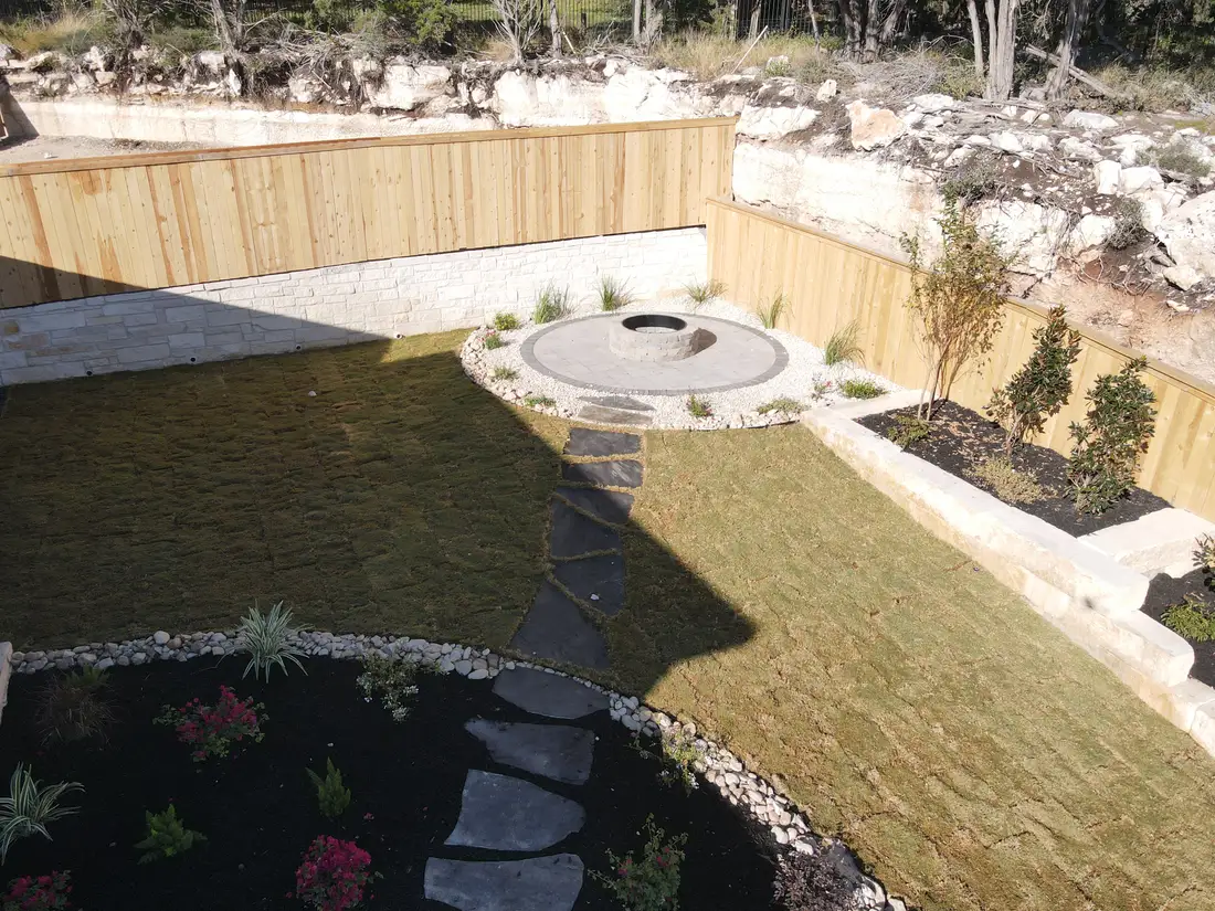 Aerial view of a terraced hillside backyard at Hidden Canyon with a circular paver patio