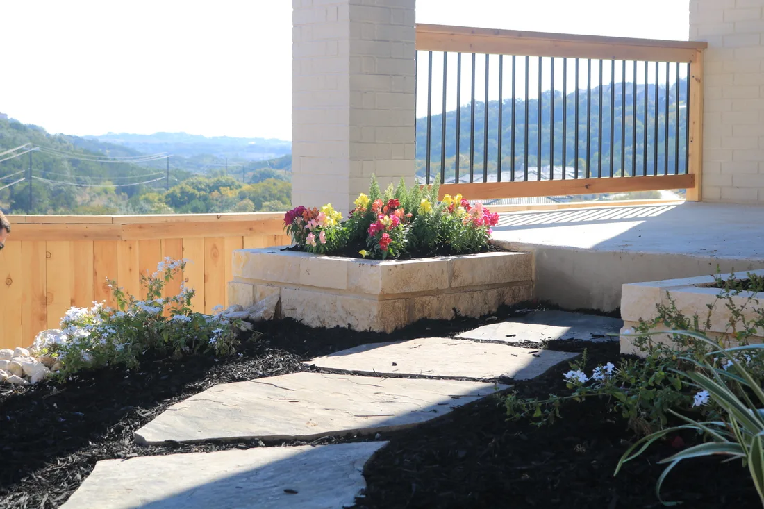 Flagstone stepper path and a limestone planter overlooking the Hill Country