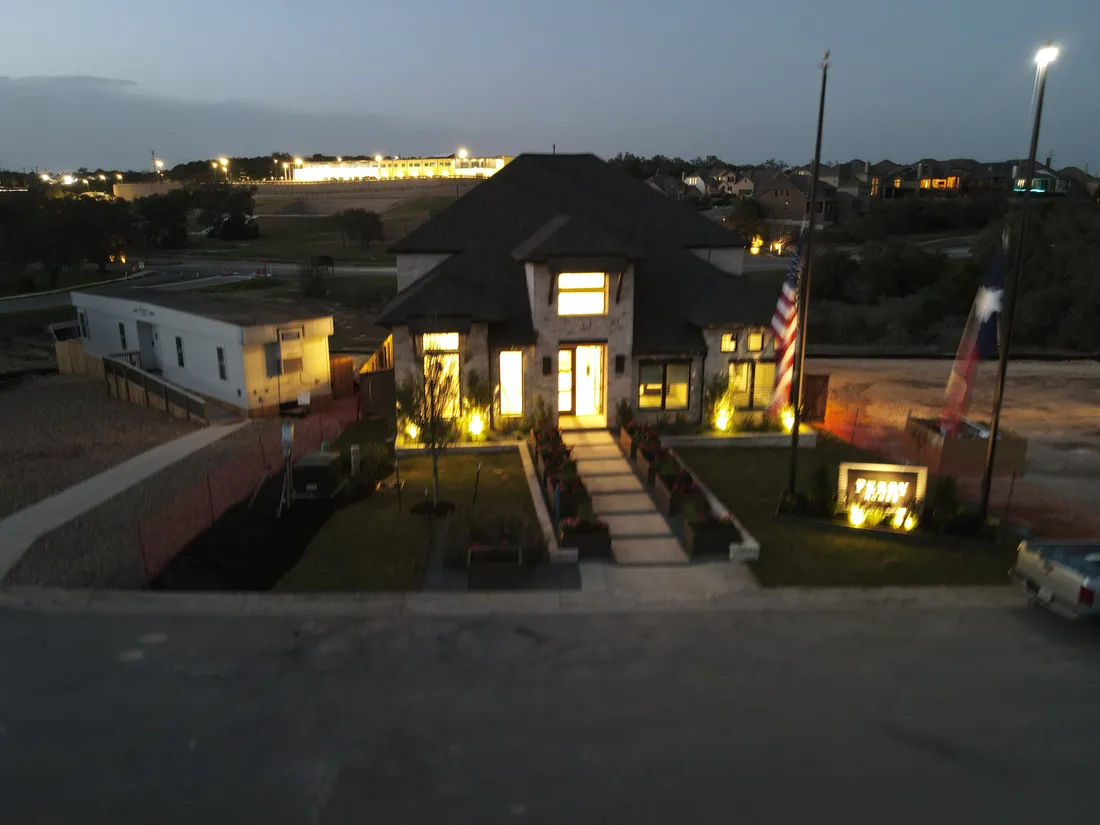 The Johnson Ranch model home at dusk with the landscape lighting on