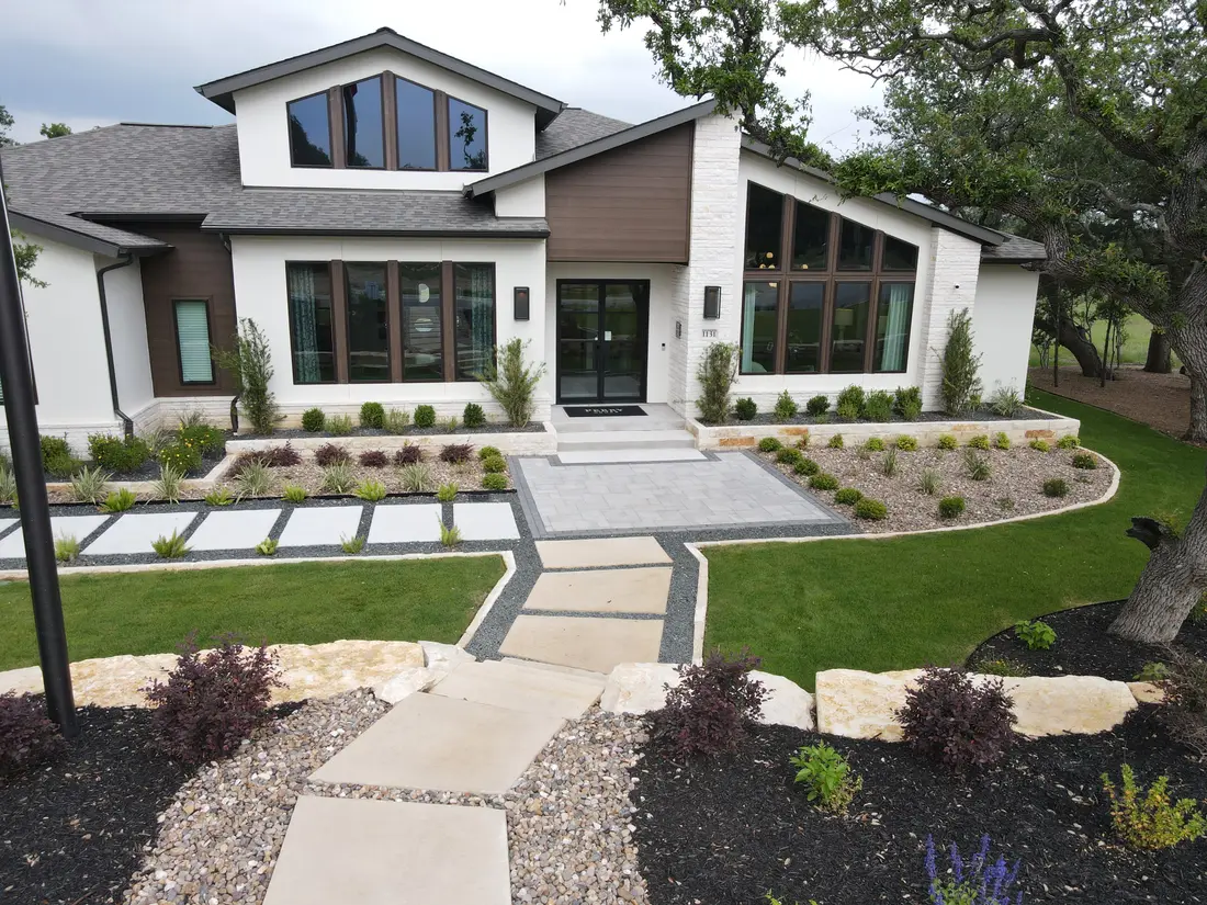 Oversized concrete stepper walkway through planted beds at the Thornebrooke model home