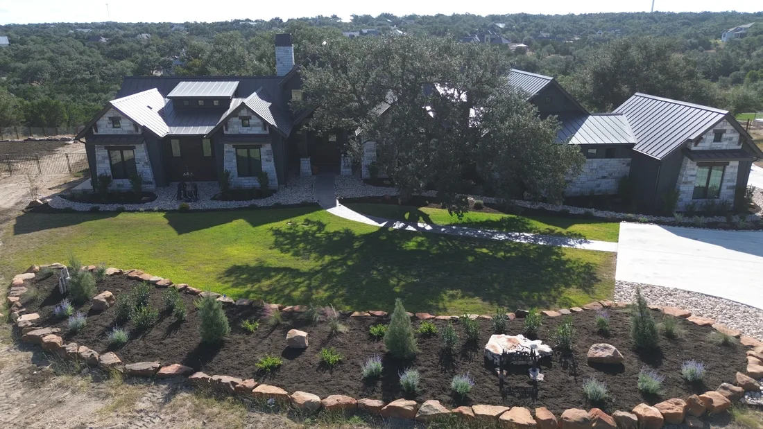 Aerial view of a graded back lawn with a stone edged bed carrying water away from the house