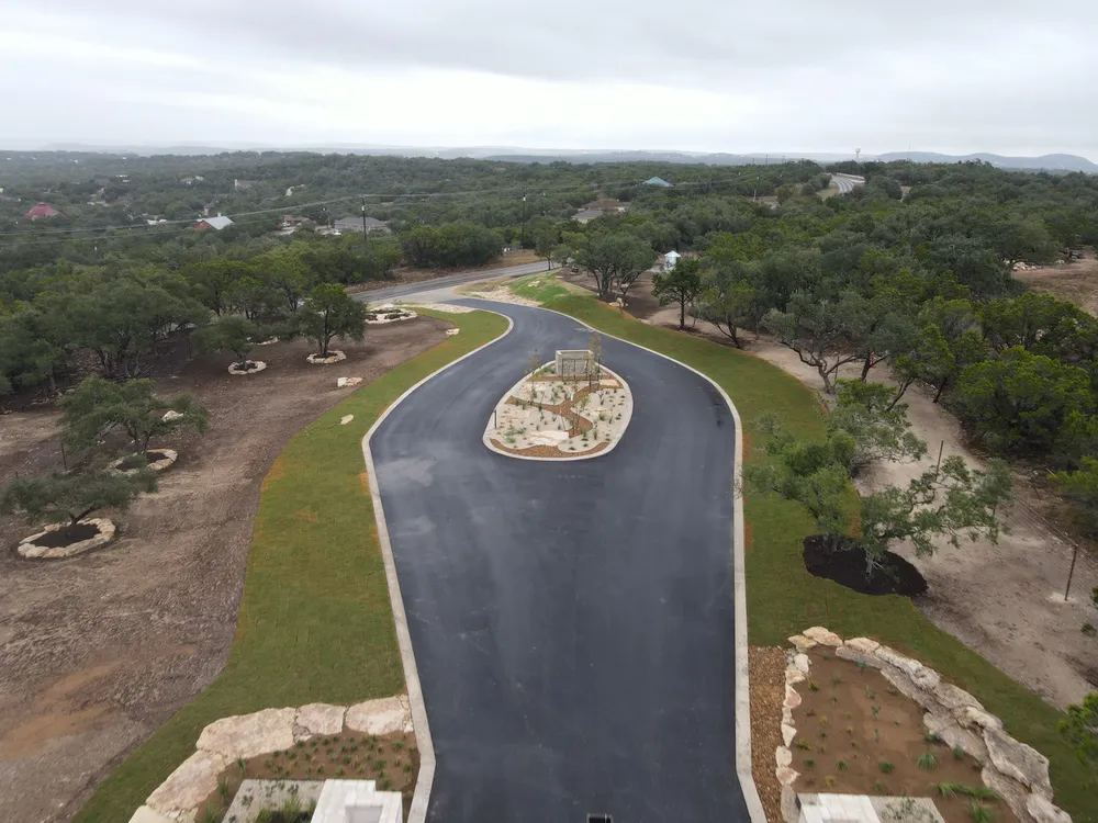 Aerial view of the entry drive at Ranches at Canyon Crossing curving around a planted island