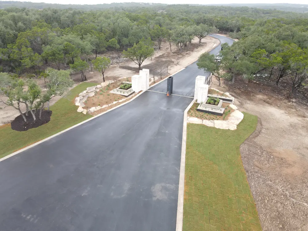 The entry road at Ranches at Canyon Crossing with its limestone monument