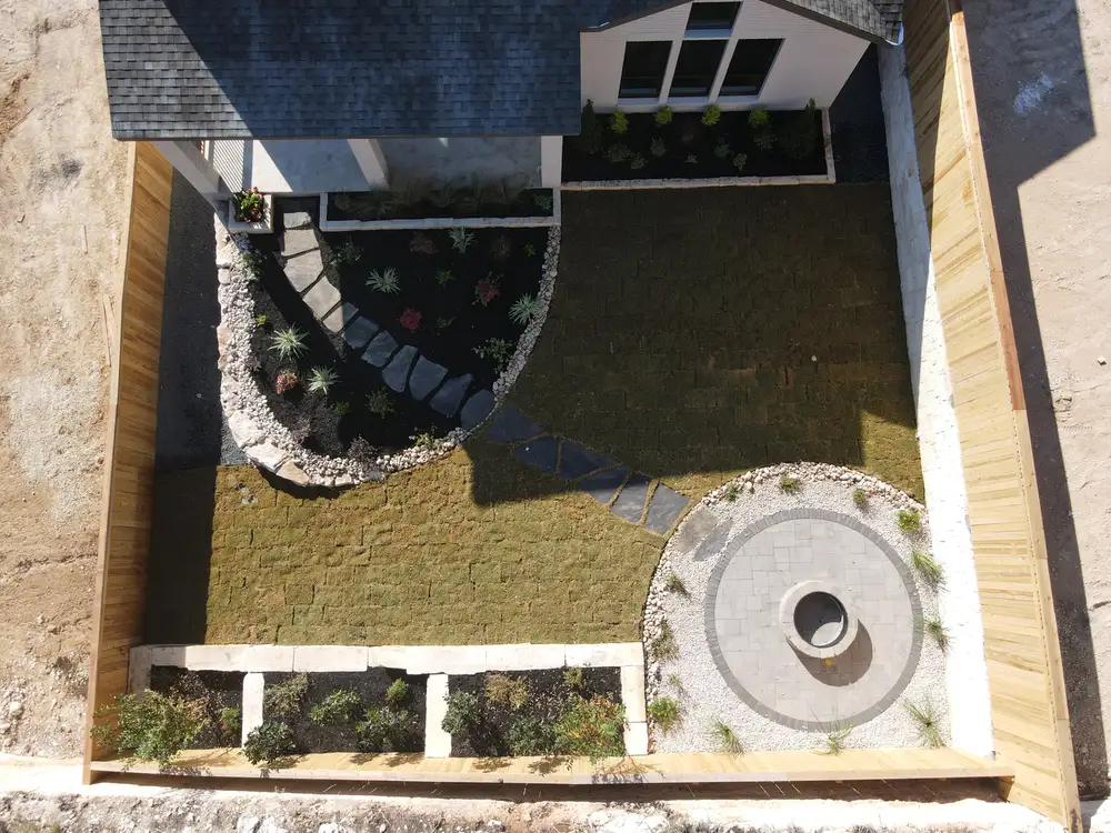Aerial view of a circular paver patio set into a terraced limestone wall