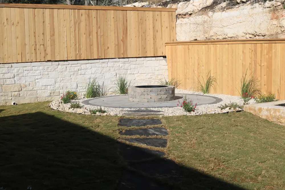 Limestone terrace wall with a circular patio and flagstone steppers