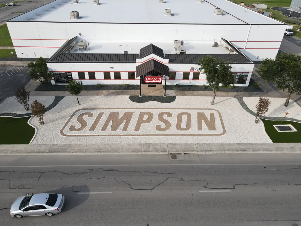 Aerial view of the Simpson Racing frontage with the company name laid out in the forecourt