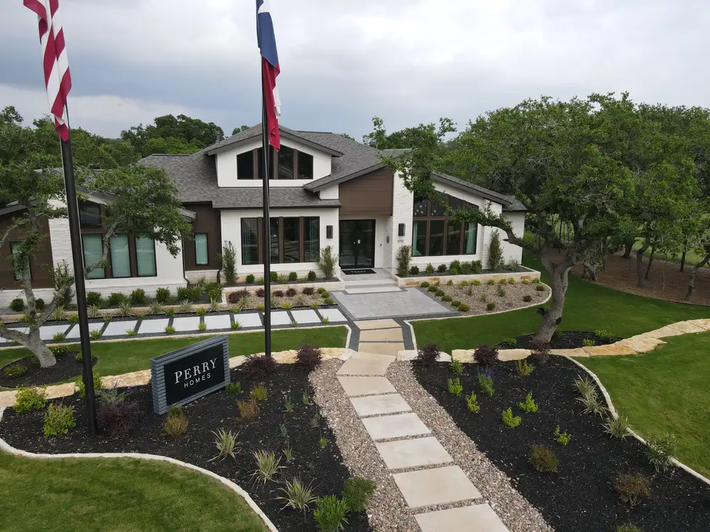 Perry Homes model home at Thornebrooke with a flagpole and new front lawn